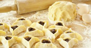 Preparing pastries with poppy seed (Hamantaschen) for Purim