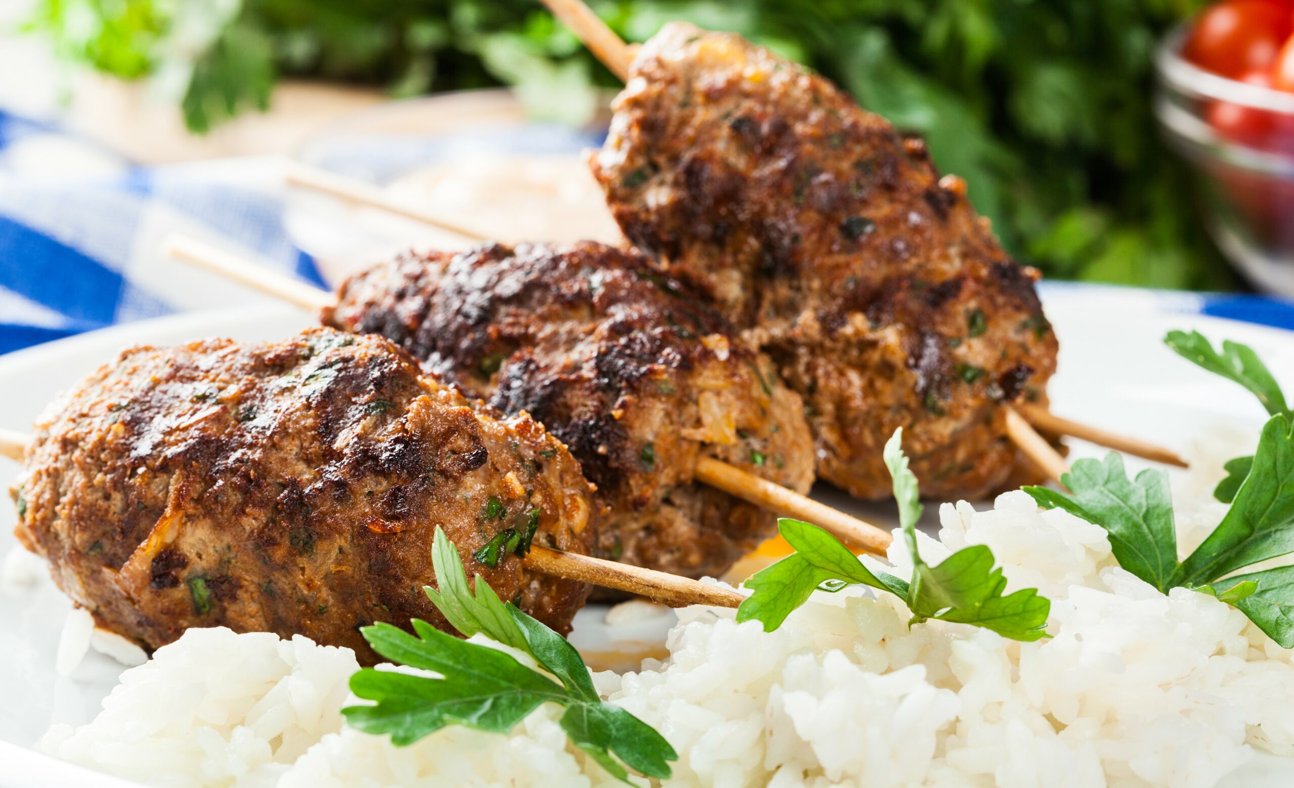 Barbecued kofta with rice on a plate. Selective focus