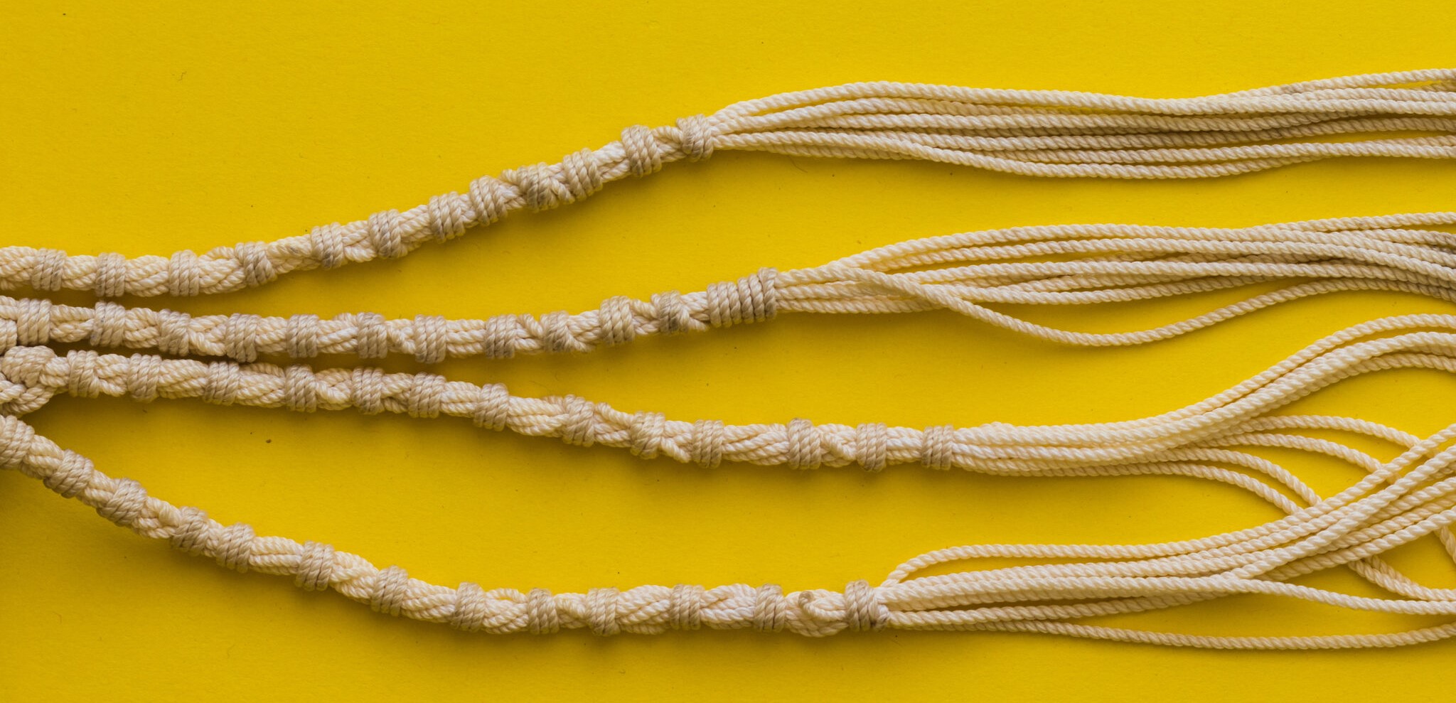 Tallit threads made of sheep wool, yellow background