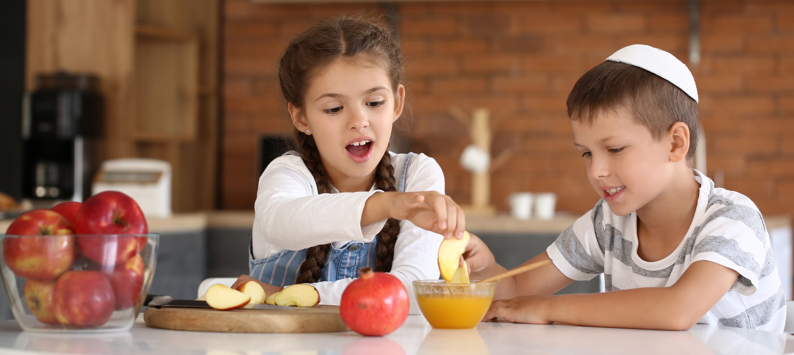 Little children celebrating Rosh Hashanah (Jewish New Year) at home